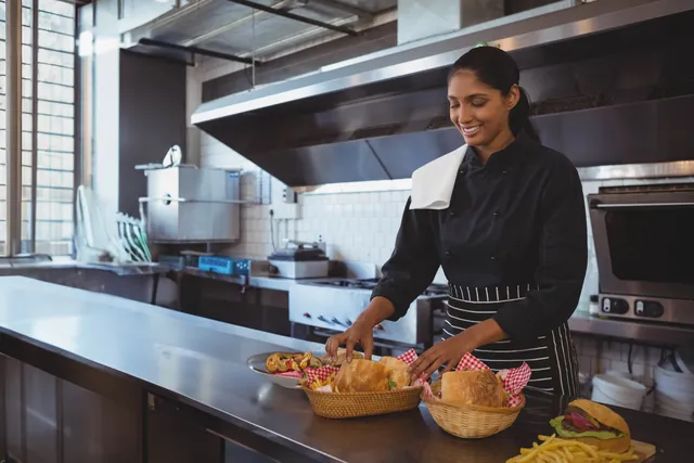 Chef preparing food in a bright commercial kitchen