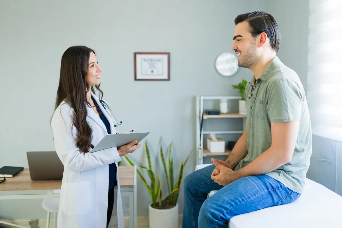 Doctor consulting a smiling patient in a bright clinic