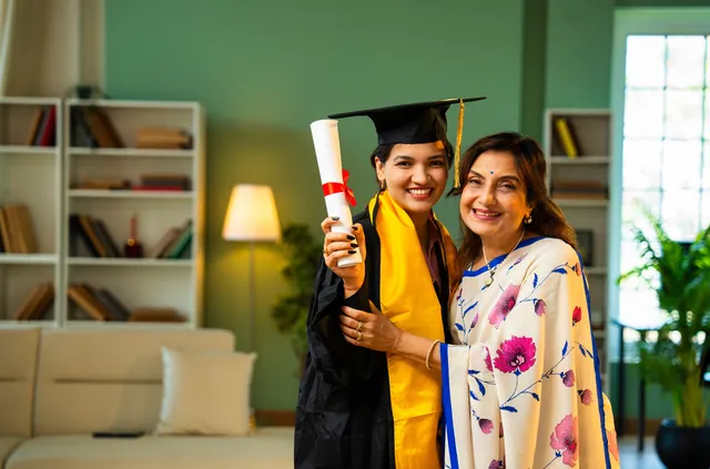 Graduate in cap and gown celebrating with her proud mother