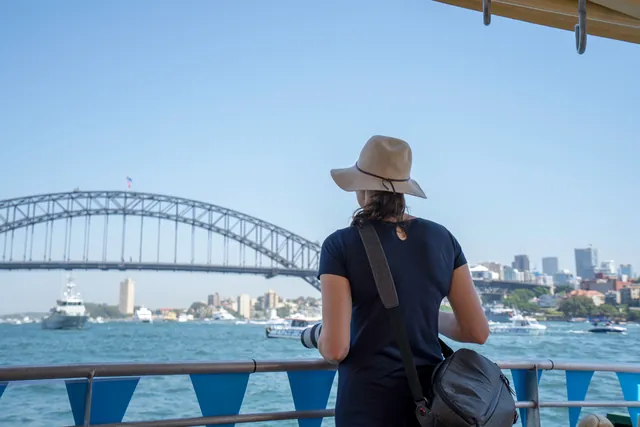 Traveller on a ferry looking at the Sydney Harbour Bridge